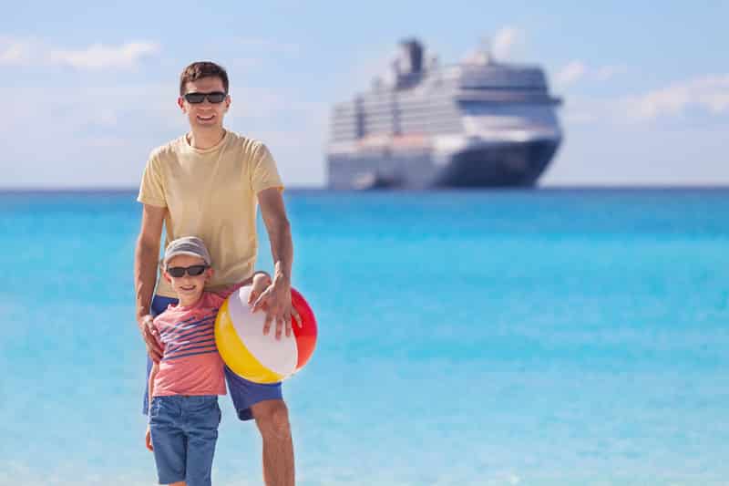 happy family with beach toy enjoying summer vacation with cruise ship in the background